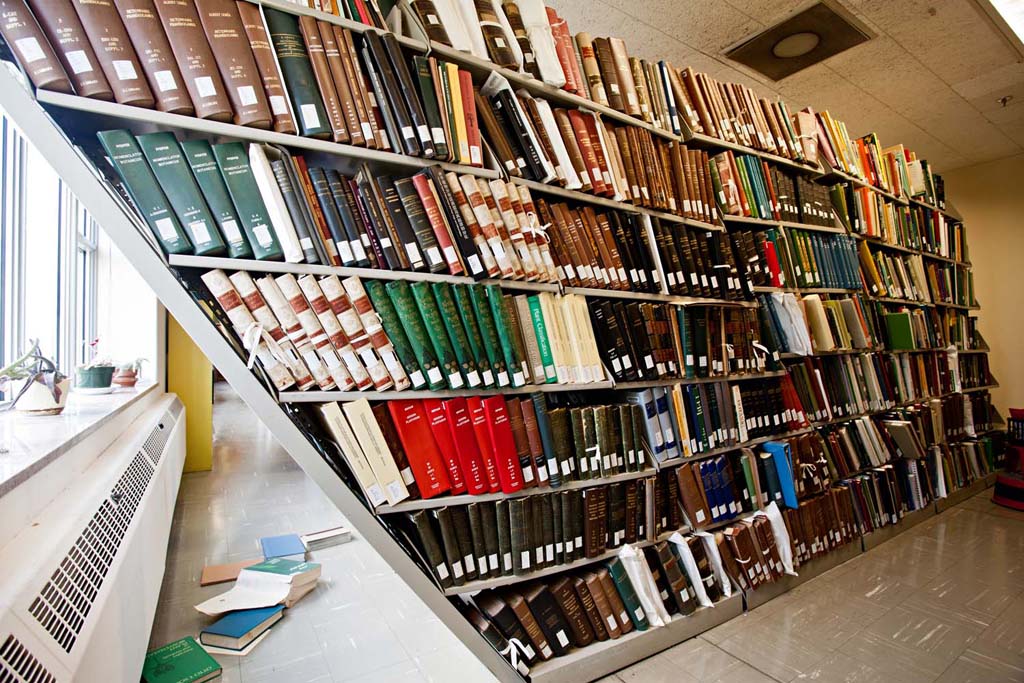 Damaged bookshelves in the Botany and Horticulture Library at the Smithsonian's National Museum of Natural History after the August 2011 Virginia earthquake, photographed by James DiLoreto, from https://www.si.edu/newsdesk/photos/earthquake-damage-botany-library