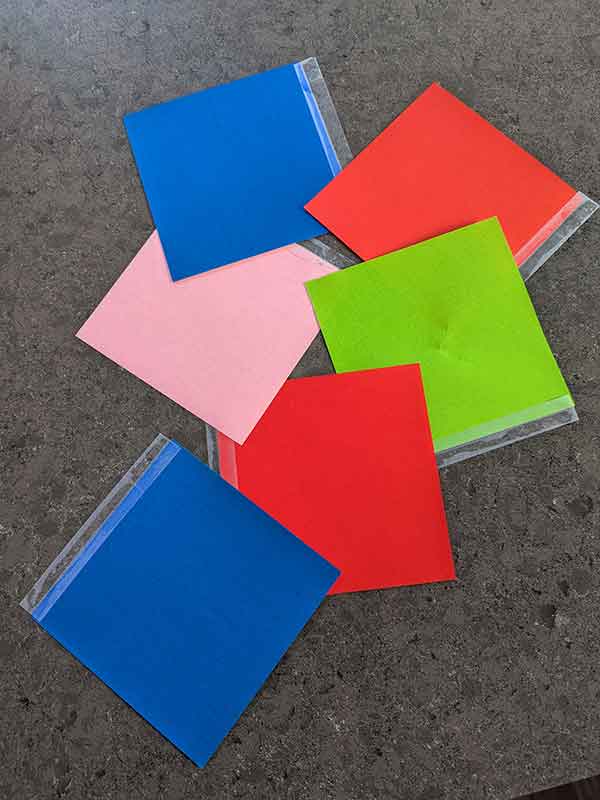 "Flaps and flips": origami squares taped to a tabletop