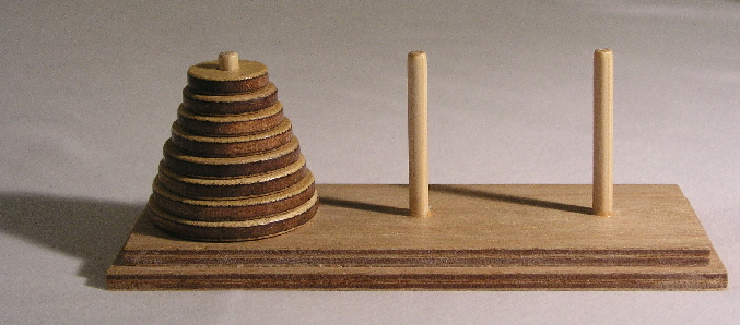 Photo of a wooden Tower of Hanoi puzzle. CC-BY-SA 3.0 image by User:Evanherk from https://commons.wikimedia.org/wiki/File:Tower_of_Hanoi.jpeg