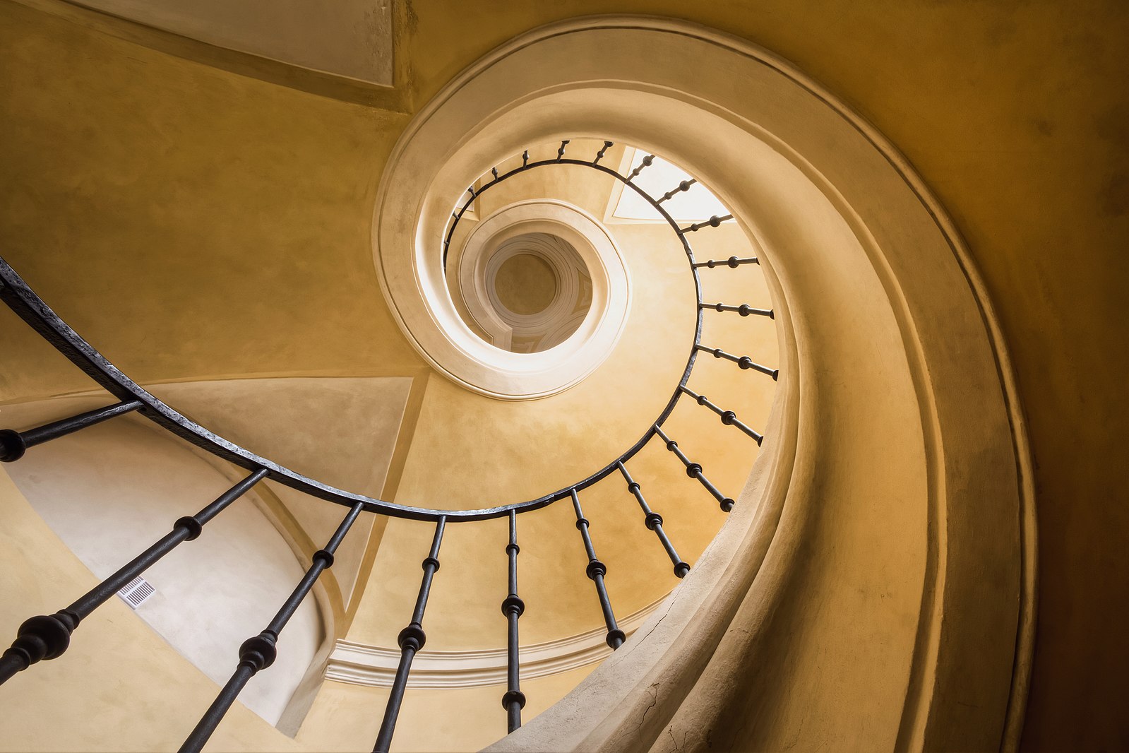 Stairs by Czech architect Jan Blažej Santini-Aichel (1677-1723), Church of the Assumption of Our Lady and Saint John the Baptist, Kutná Hora, Czech Republic. CC-BY 2.0 licensed image by Brad Hammonds, March 24, 2013, from https://commons.wikimedia.org/wiki/File:Golden_Spiral_by_Brad_Hammonds.jpg